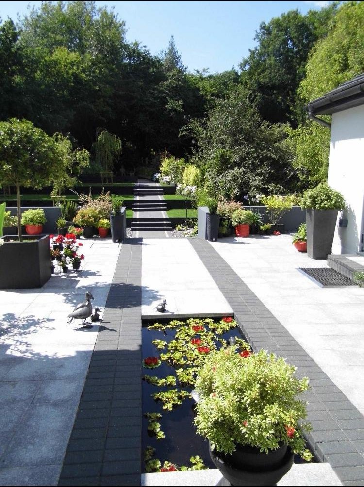 Modern terrace with long water feature and steps